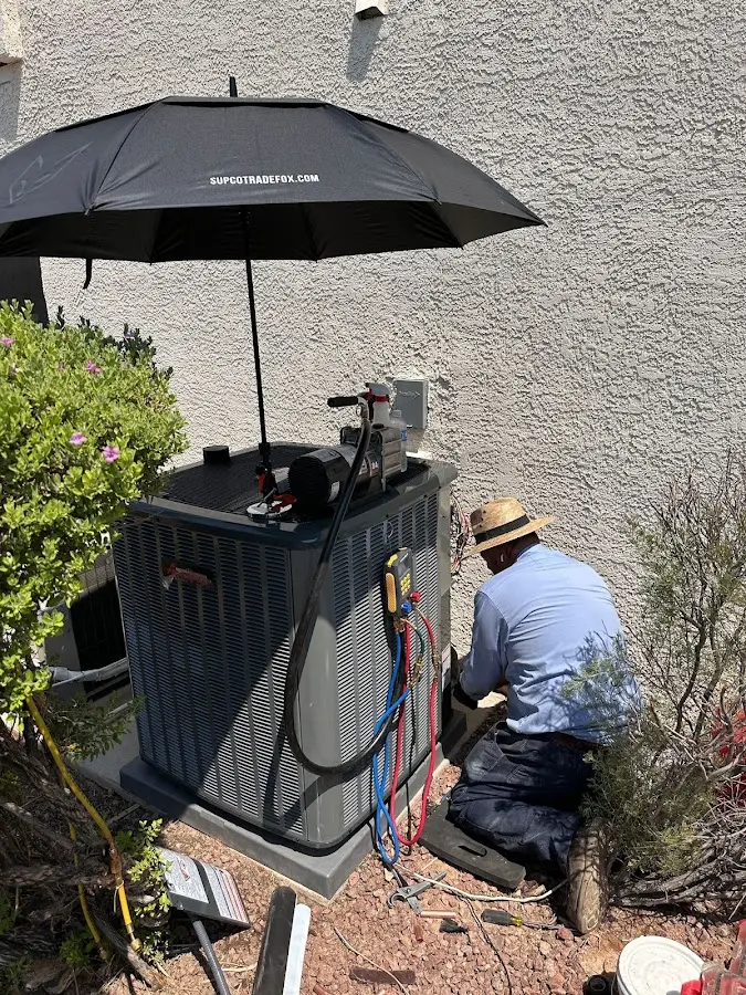 HVAC technician performing outdoor AC maintenance in Farmington Hills
